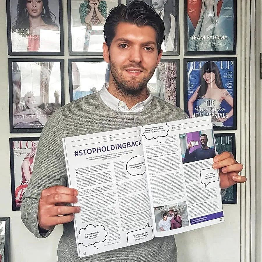 A Stop Holding Back member holding a printed article about the campaign